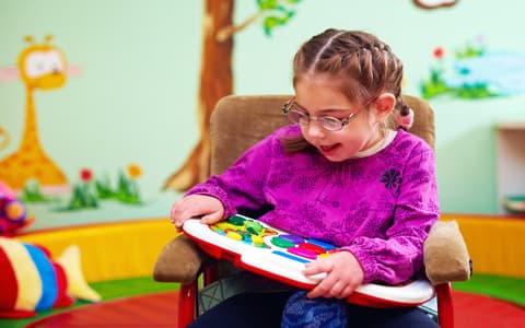 Young Girl With Cerebral Palsy Playing With Game Board