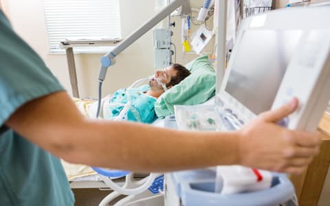 Patient Laying In Bed Attached To Oxygen