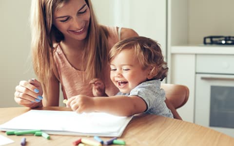 Mother Playing With Young Son At Table