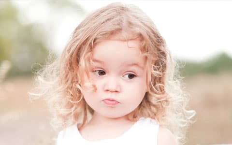 Portrait Image Of Young Child With Blond Curly Hair