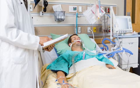 Patient Laying In Bed Attached To Oxygen