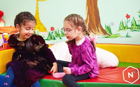 Young Girls Sat Together Chatting 