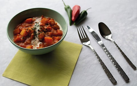 Food In Bowl On Table With Cutlery